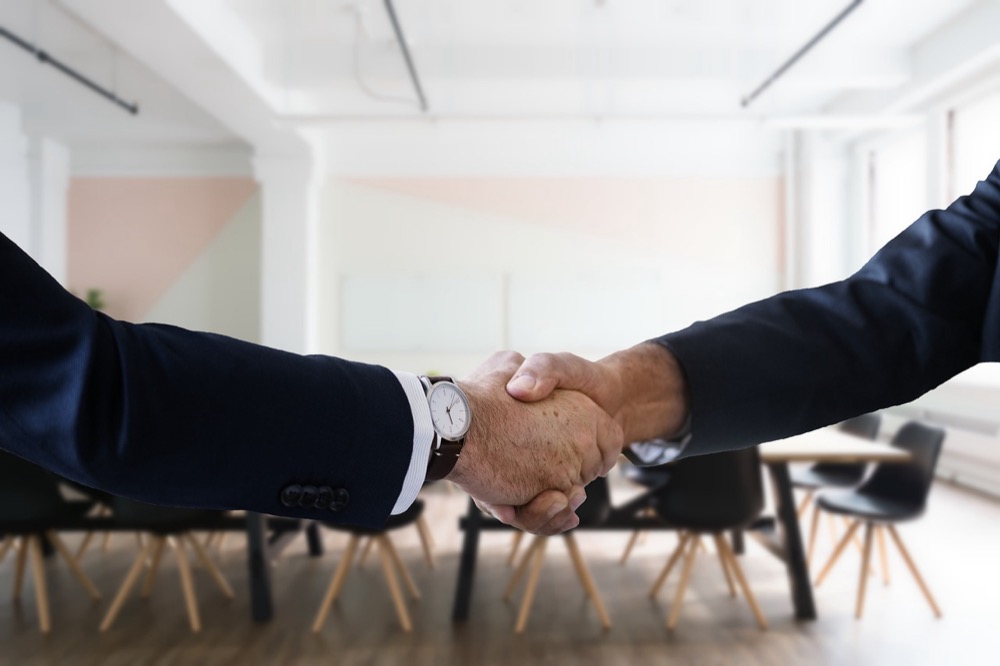A job candidate at an interview handshake - free practice for the Walmart assessment that comes before it